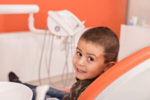 Happy, dark-haired boy getting sedation dentistry before a procedure
